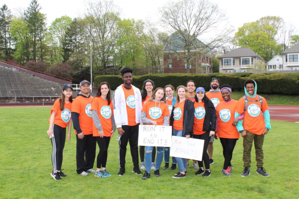 volunteers stand in a field for a group photo